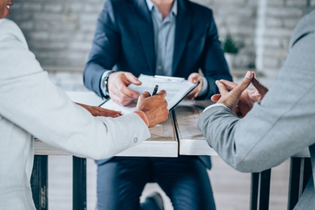 couple signing documents with a mediator