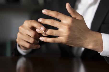 person removing wedding ring