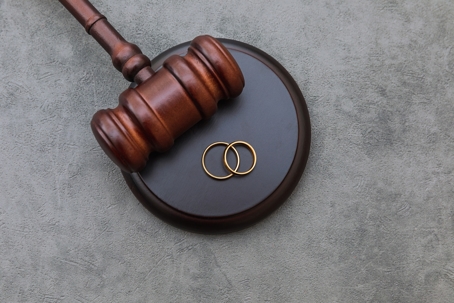 gavel with two wedding rings