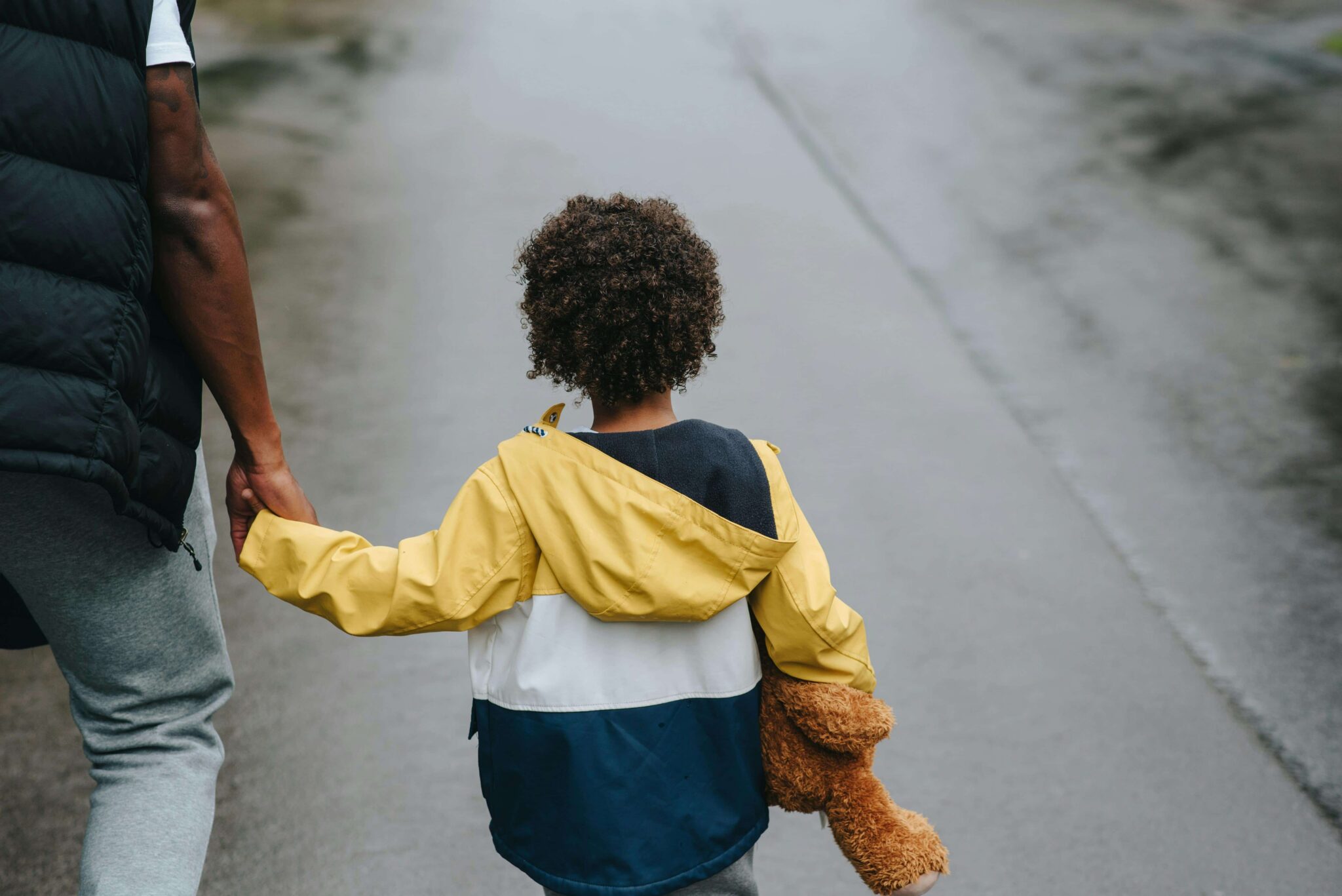 Parent and child walking together outdoors, representing changes to parenting arrangements and child custody modification.