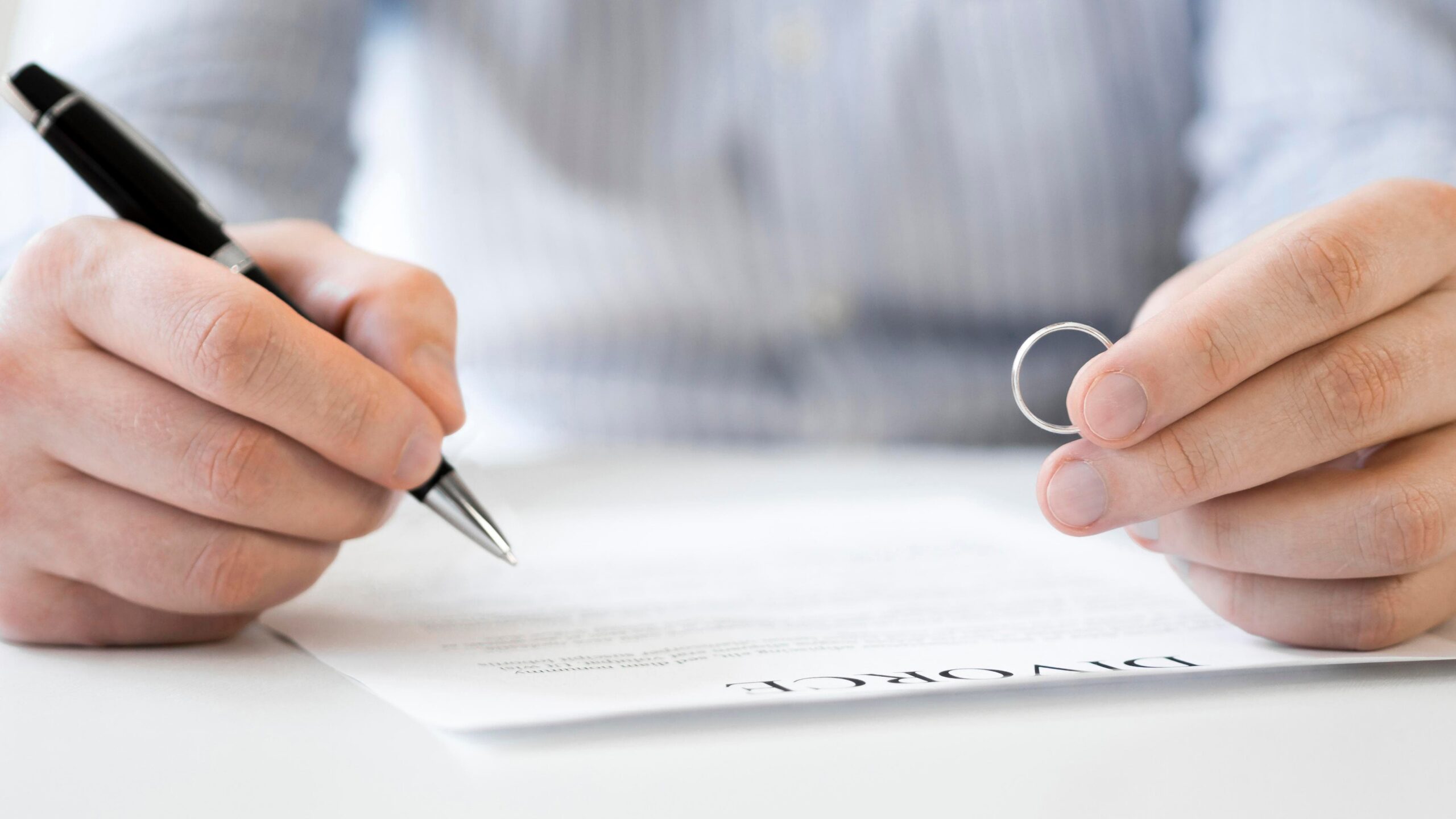 A man carefully reviewing legal paperwork, representing a preparation checklist of what to do before filing for divorce in Colorado.